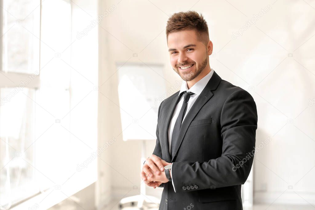 Portrait of handsome young businessman in office