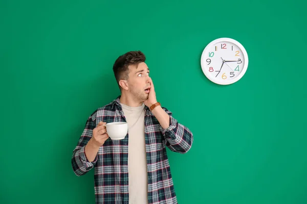 Shocked Young Man Coffee Looking Clock Color Background — Stock Photo, Image