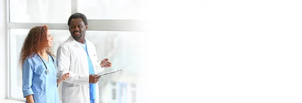 African-American doctors near window in clinic