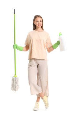 Beyaz arka planda paspas ve deterjanı olan genç bir kadın.