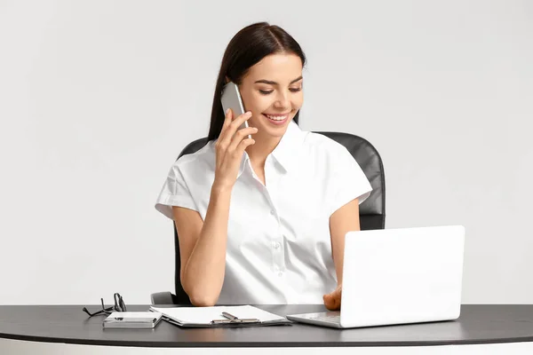 Hermosa Joven Secretaria Hablando Por Teléfono Mesa Sobre Fondo Blanco — Foto de Stock