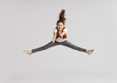 Işıklı arka planda zıplayan tatlı kız.