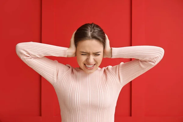 Young Woman Suffering Loud Noise Color Background — Stock Photo, Image