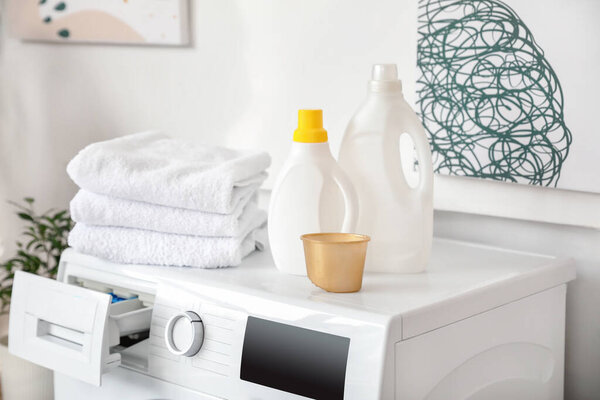 Detergents and laundry on washing machine