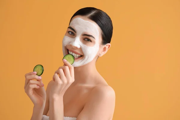 Mooie Jonge Vrouw Met Komkommer Plakjes Gezichtsmasker Kleur Achtergrond — Stockfoto