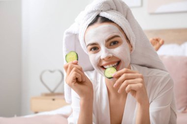 Morning of beautiful young woman taking care of her skin at home clipart