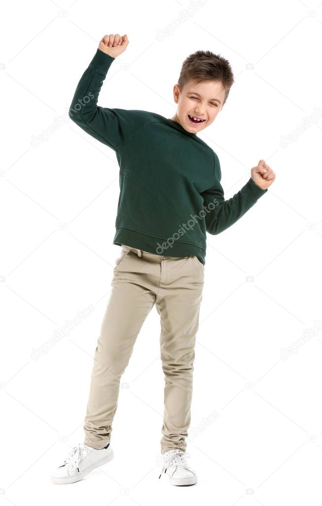 Cute little boy dancing against white background