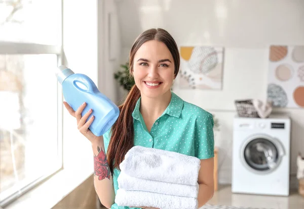 家できれいなタオルや洗剤を持つ若い女性 — ストック写真