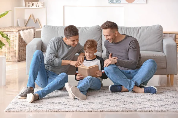 Happy Gay Couple Adopted Child Reading Book Home — Stock Photo, Image