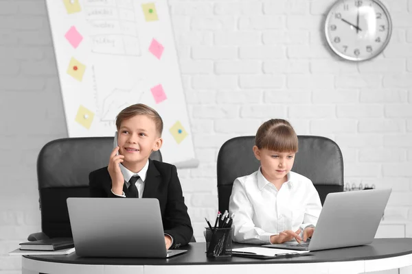 Little secretaries working in office