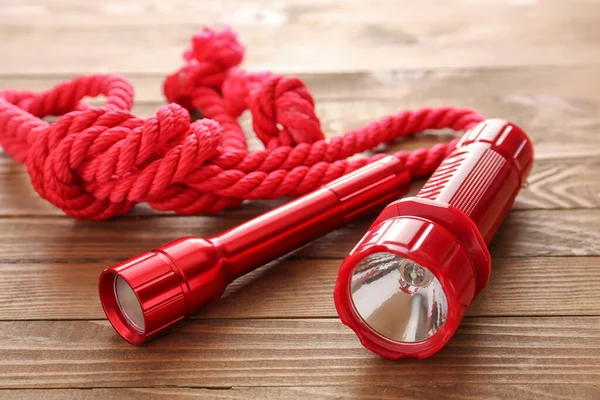 Modern Flashlights Rope Wooden Background — Stock Photo, Image