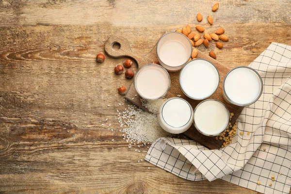 Gläser Verschiedener Milch Auf Hölzernem Hintergrund — Stockfoto