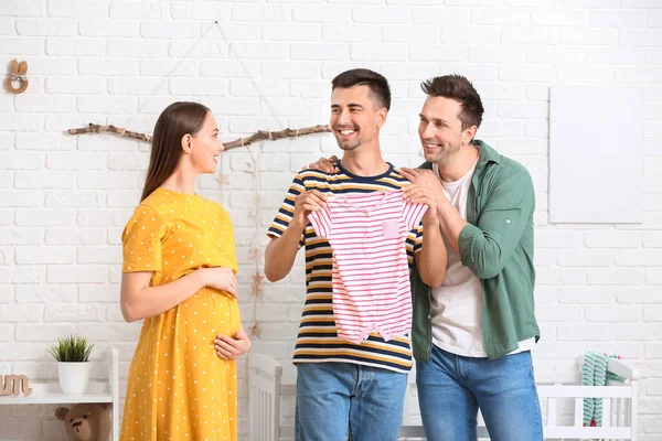 Gay Couple Pregnant Woman Baby Clothes Home — Stock Photo, Image