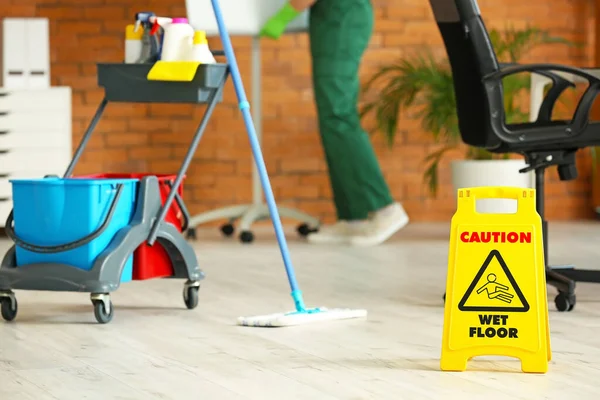 stock image Male janitor cleaning in office