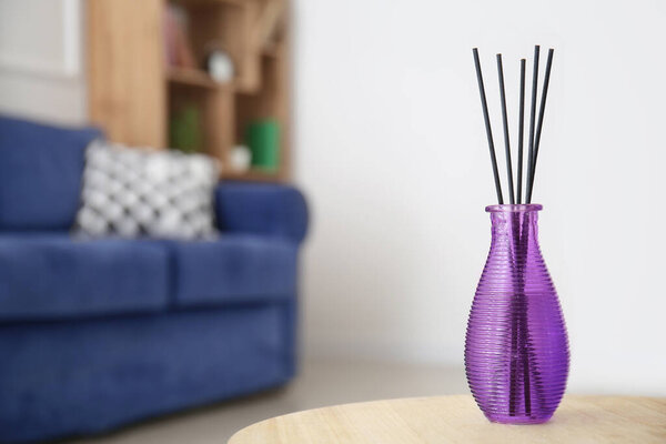 Reed diffuser on table in room