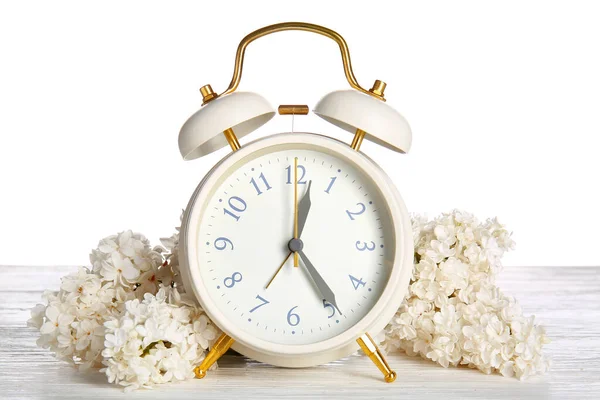 Alarm Clock Flowers Table White Background Spring Time — Stock Photo, Image