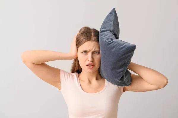Young Woman Suffering Loud Noise Light Background — Stock Photo, Image