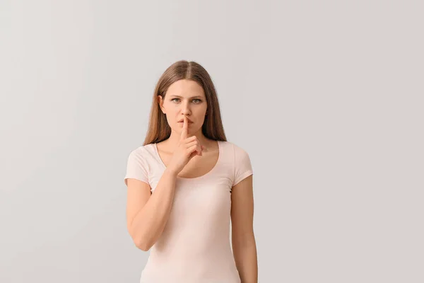 Young Woman Showing Silence Gesture Light Background — Stock Photo, Image