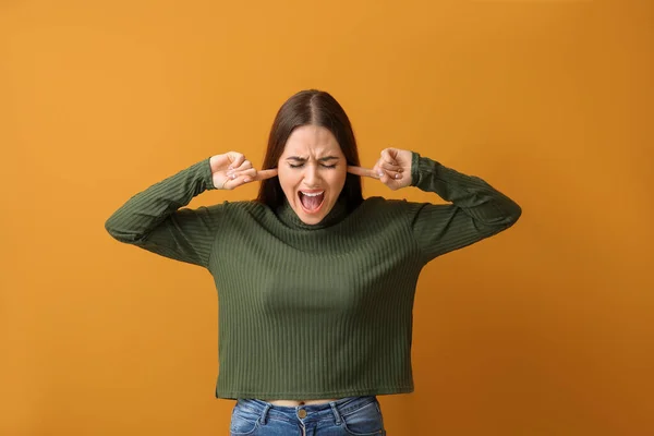 Young Woman Suffering Loud Noise Color Background — Stock Photo, Image