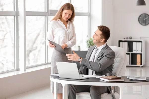 Boss and his beautiful secretary working in office