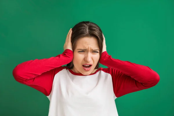 Young Woman Suffering Loud Noise Color Background — Stock Photo, Image