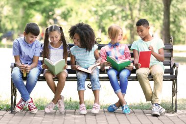 Cute kids reading books on bench clipart