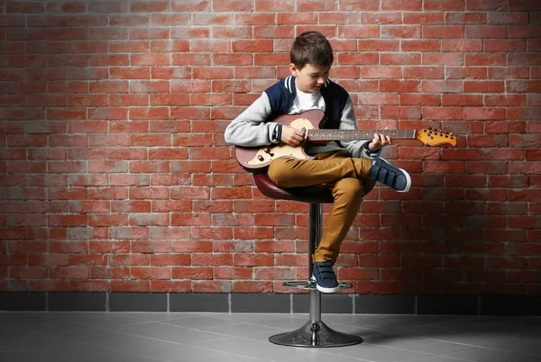 Cute Little Boy Playing Guitar Brick Wall Background — Stock Photo, Image