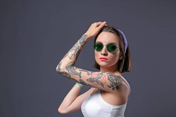Mulher Bonita Com Tatuagem Usando Óculos Sol Posando Fundo Cinza — Fotografia de Stock