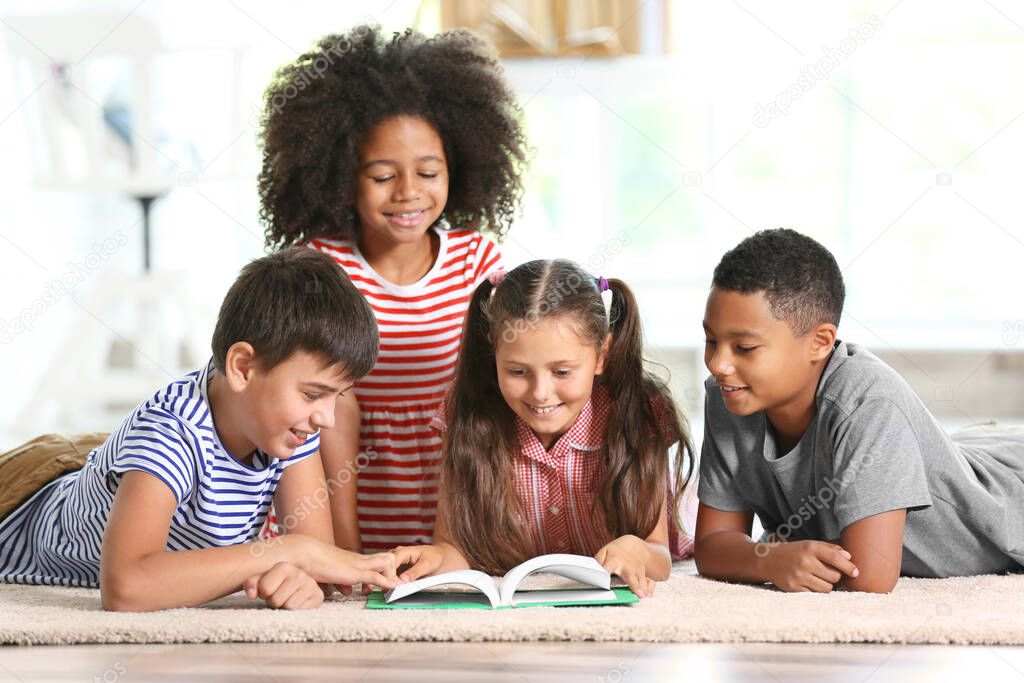 Cute kids reading book at home