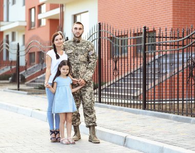 US army soldier with family on street clipart