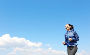 Çekici fitness kadını dışarıda koşuyor.