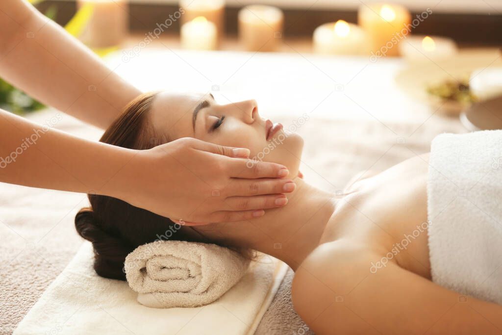 Spa concept. Young woman enjoying of facial massage in spa salon