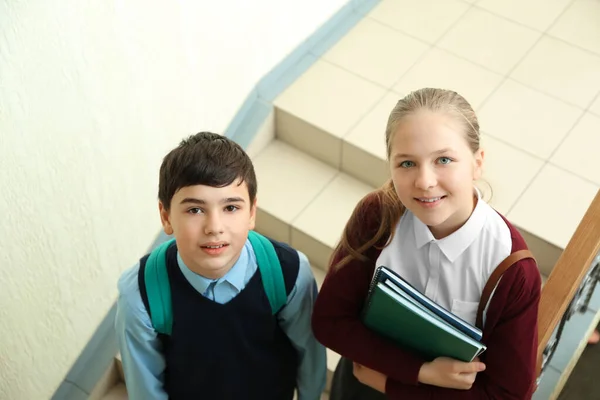 可愛いです男の子と女の子で学校制服上の階段に立って — ストック写真