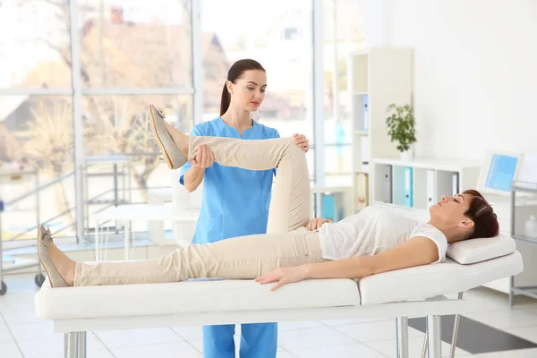 Female Orthopedist Massaging Middle Aged Woman Clinic — Stock Photo, Image