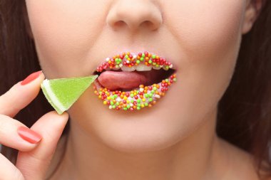 Yaratıcı makyajı ve marmeladı olan genç ve güzel bir kadın.