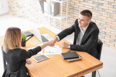 İnsan kaynakları yöneticisi başvuru yapanla tokalaşıyor