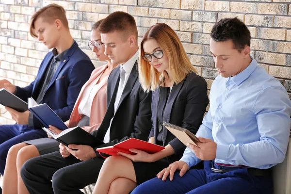 Group of people waiting for job interview on chairs