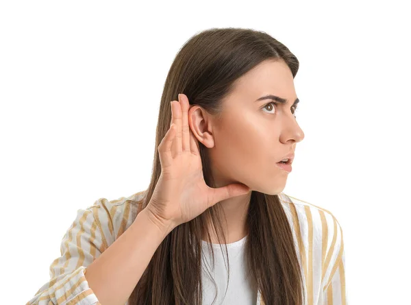 Mujer Joven Tratando Escuchar Algo Sobre Fondo Blanco —  Fotos de Stock
