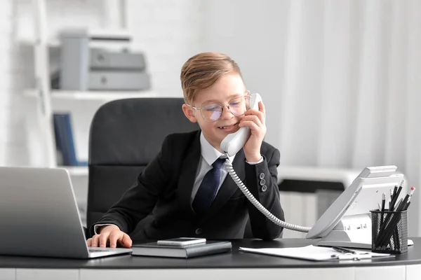 Little secretary working in office