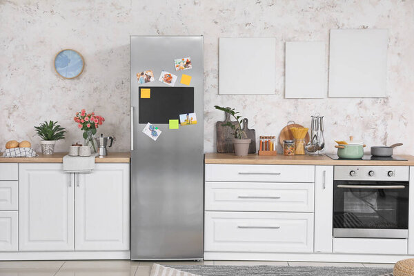 Interior of modern kitchen with refrigerator