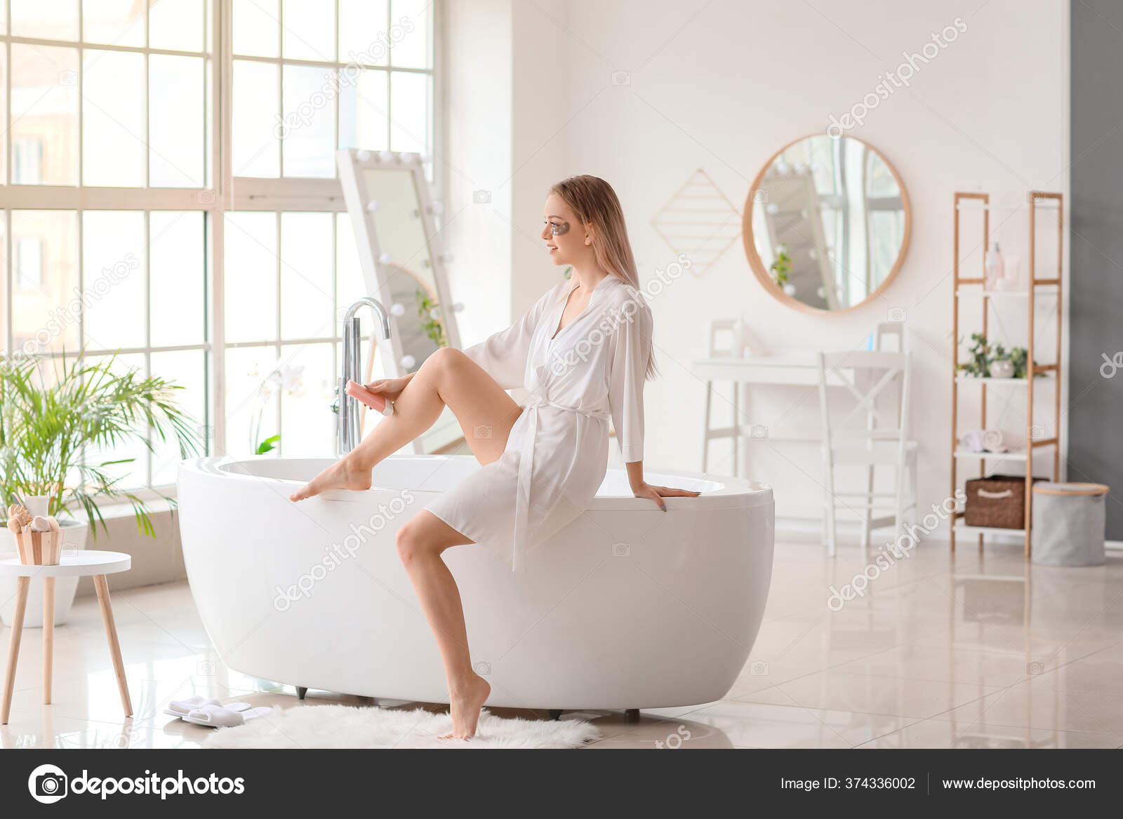 Beautiful Young Woman Epilating Legs Bathroom Stock Photo by ©serezniy 374336002