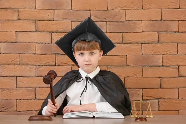 Portrait Little Judge Sitting Table Brick Background — Stock Photo, Image