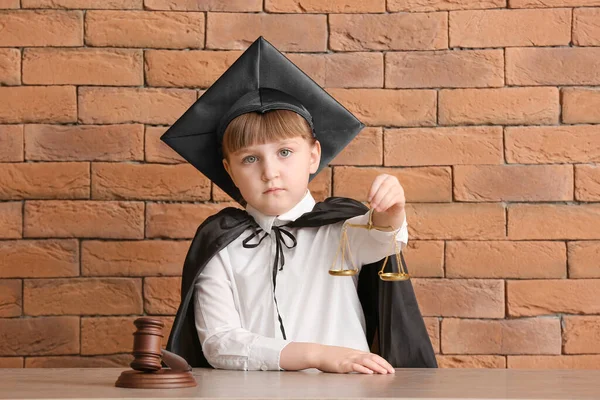 Portrait Little Judge Sitting Table Brick Background — Stock Photo, Image