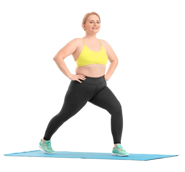 体重超标的妇女在白色背景下练习瑜伽 — 图库照片