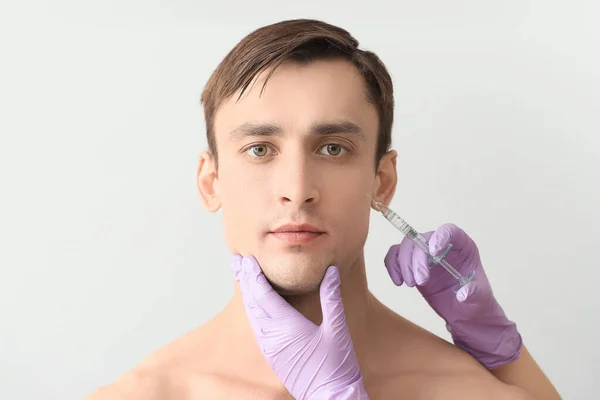 Handsome Man Receiving Filler Injection Light Background — Stock Photo, Image