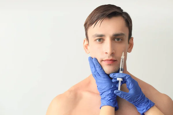 Handsome Man Receiving Filler Injection Light Background — Stock Photo, Image