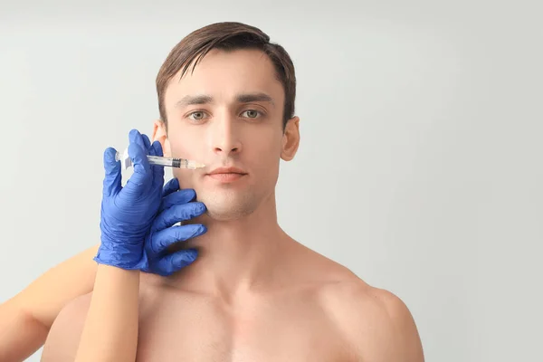 Handsome Man Receiving Filler Injection Light Background — Stock Photo, Image