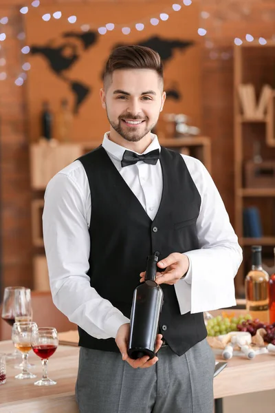 Waiter with bottle of wine at the restaurant