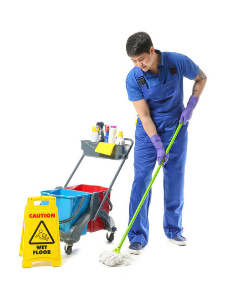 Male janitor with cleaning supplies on white background