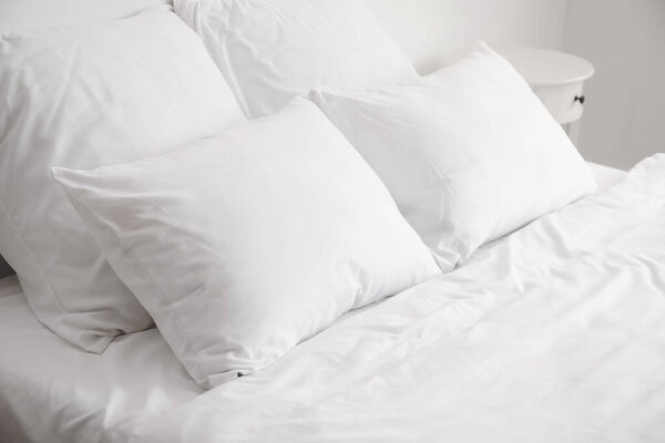 Big comfortable bed with clean linen in room